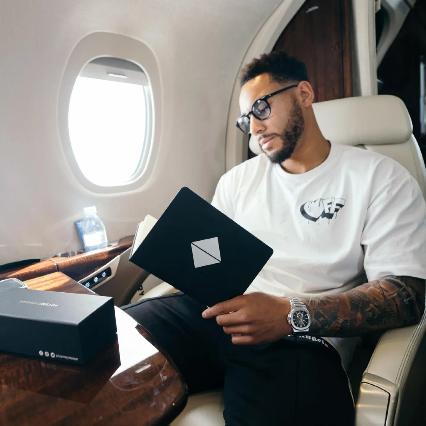 Pryzm Eyewear branded case and box on a private jet